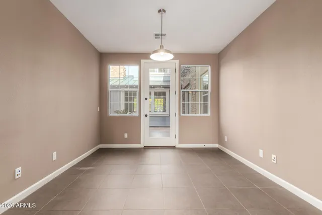 a utility room with stainless steel appliances granite countertop a sink a washer and dryer with wooden cabinets