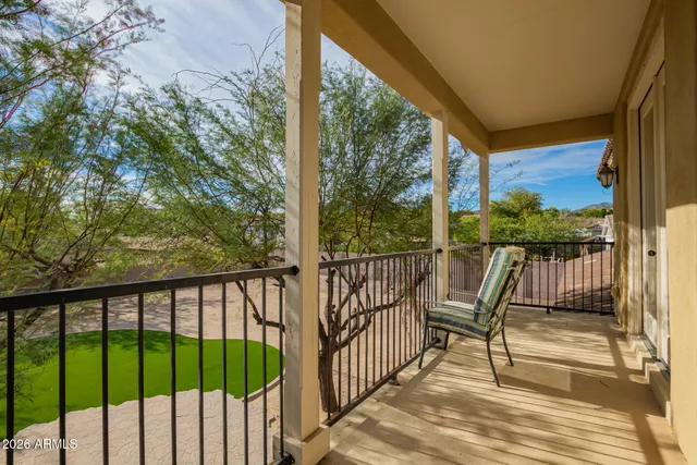 a view of a patio with table and chairs with wooden floor and fence