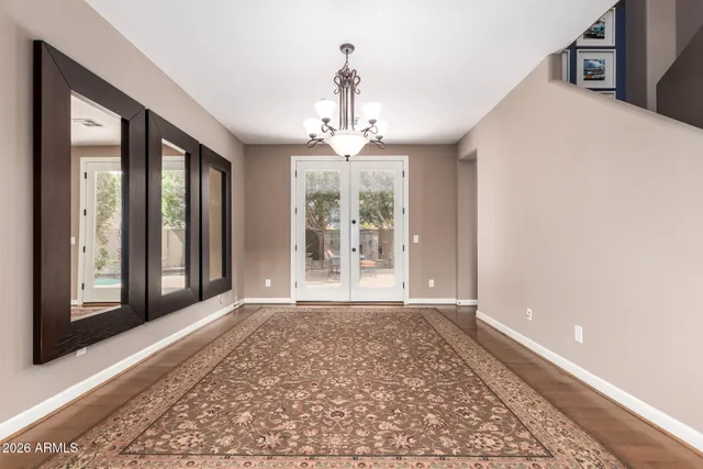 a view of a big room with windows and chandelier