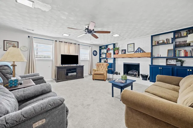 a living room with furniture and a fireplace