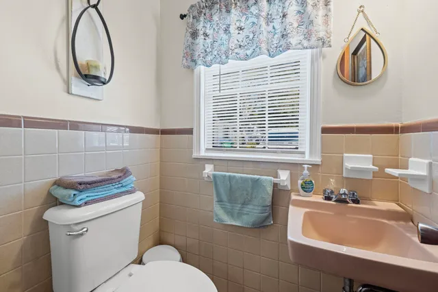 a kitchen with stainless steel appliances a sink a stove a refrigerator and cabinets