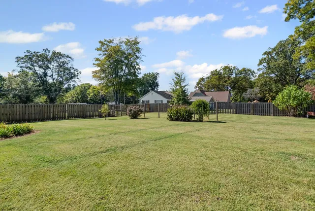 a view of a patio with table and chairs and potted plants