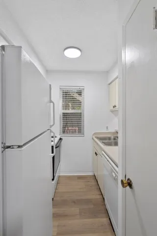 a view of a hallway with washer and dryer