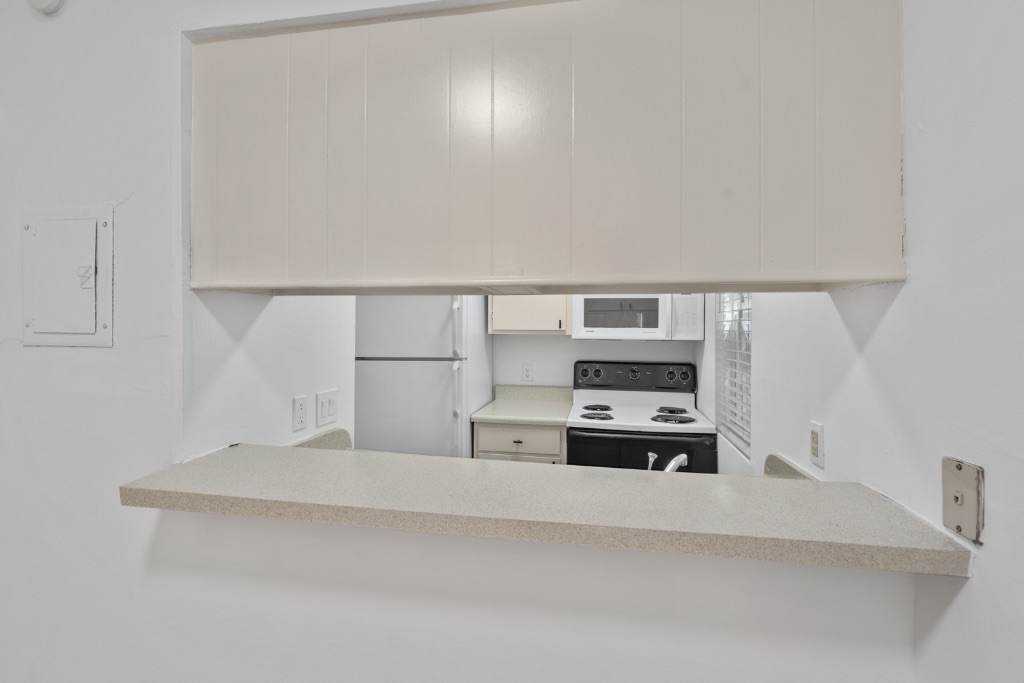 4105 Speedway, Unit 203 Austin, TX 78751 - Photo 5 of 12 a kitchen with kitchen island a sink and white cabinets
