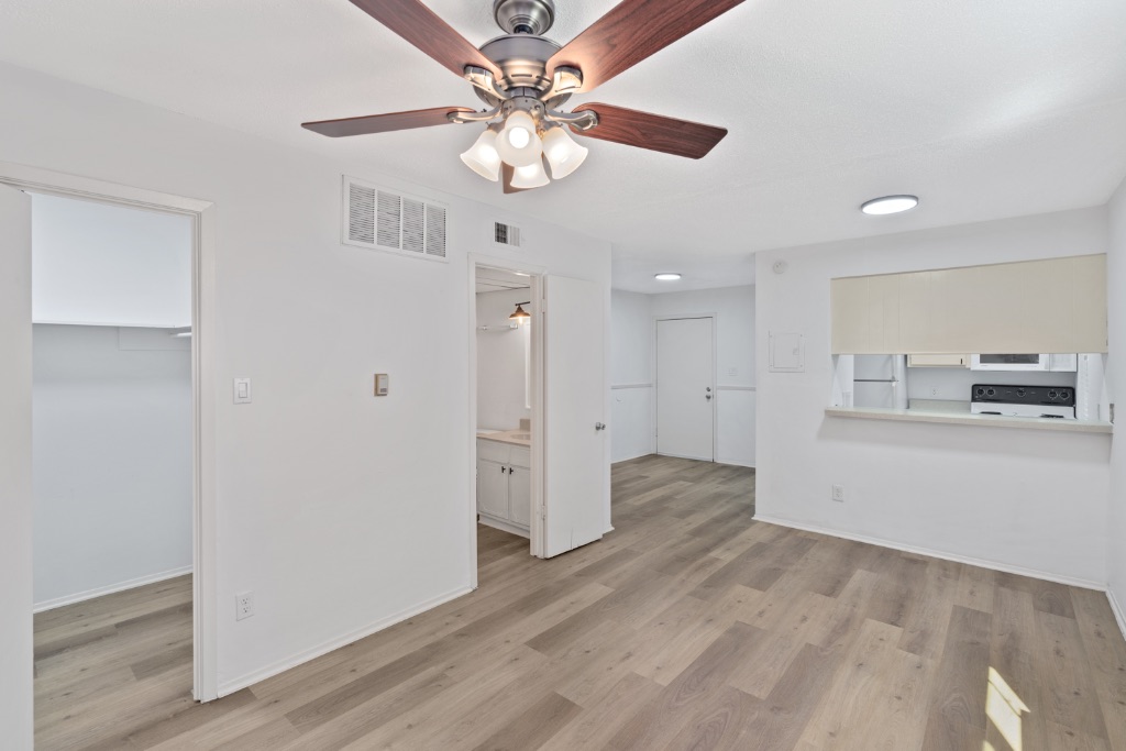 4105 Speedway, Unit 203 Austin, TX 78751 - Photo 7 of 12 a view of a kitchen with wooden floor and a ceiling fan