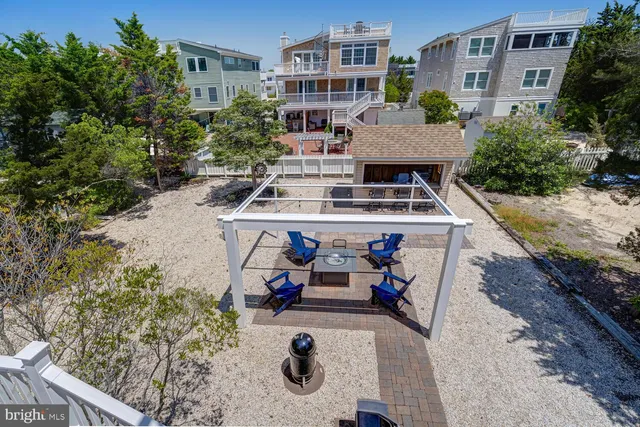 a view of a house with backyard porch and sitting area
