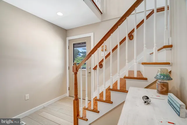 a view of entryway with wooden floor and stairs