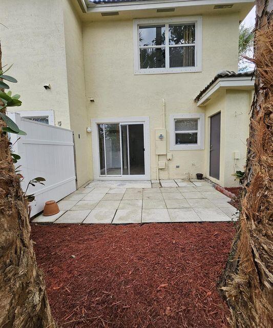 13490 Old Englishtown Road Wellington, FL 33414 - Photo 13 of 13 a view of a house with a backyard