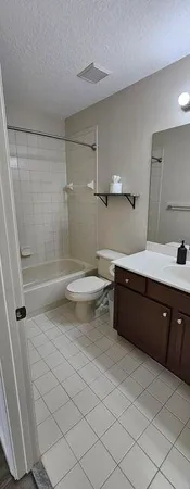 a bathroom with a double vanity sink toilet and shower