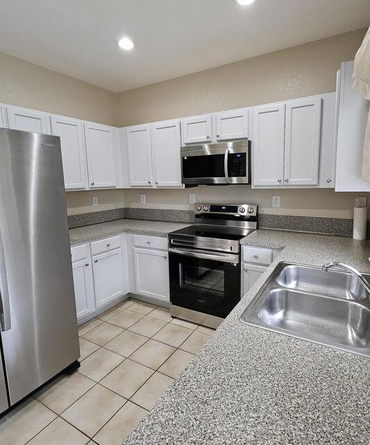 13490 Old Englishtown Road Wellington, FL 33414 - Photo 8 of 13 a kitchen with granite countertop a refrigerator stove and microwave