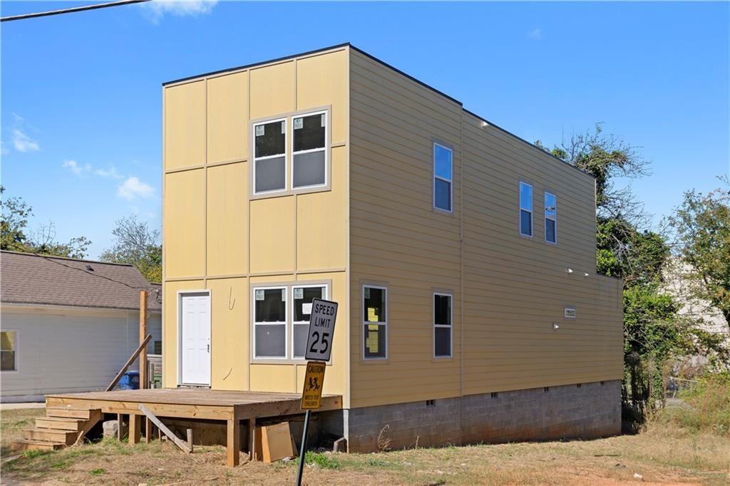 a front view of a house with large windows
