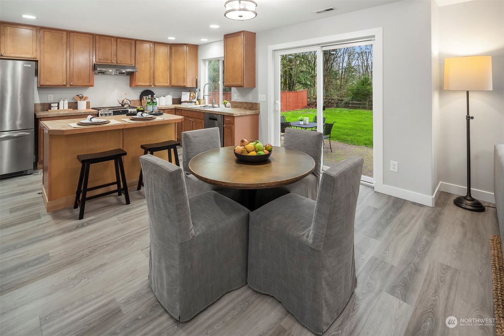 3205 Southeast 4th Street Renton, WA 98056 - Photo 7 of 38 a kitchen with a table chairs refrigerator and microwave