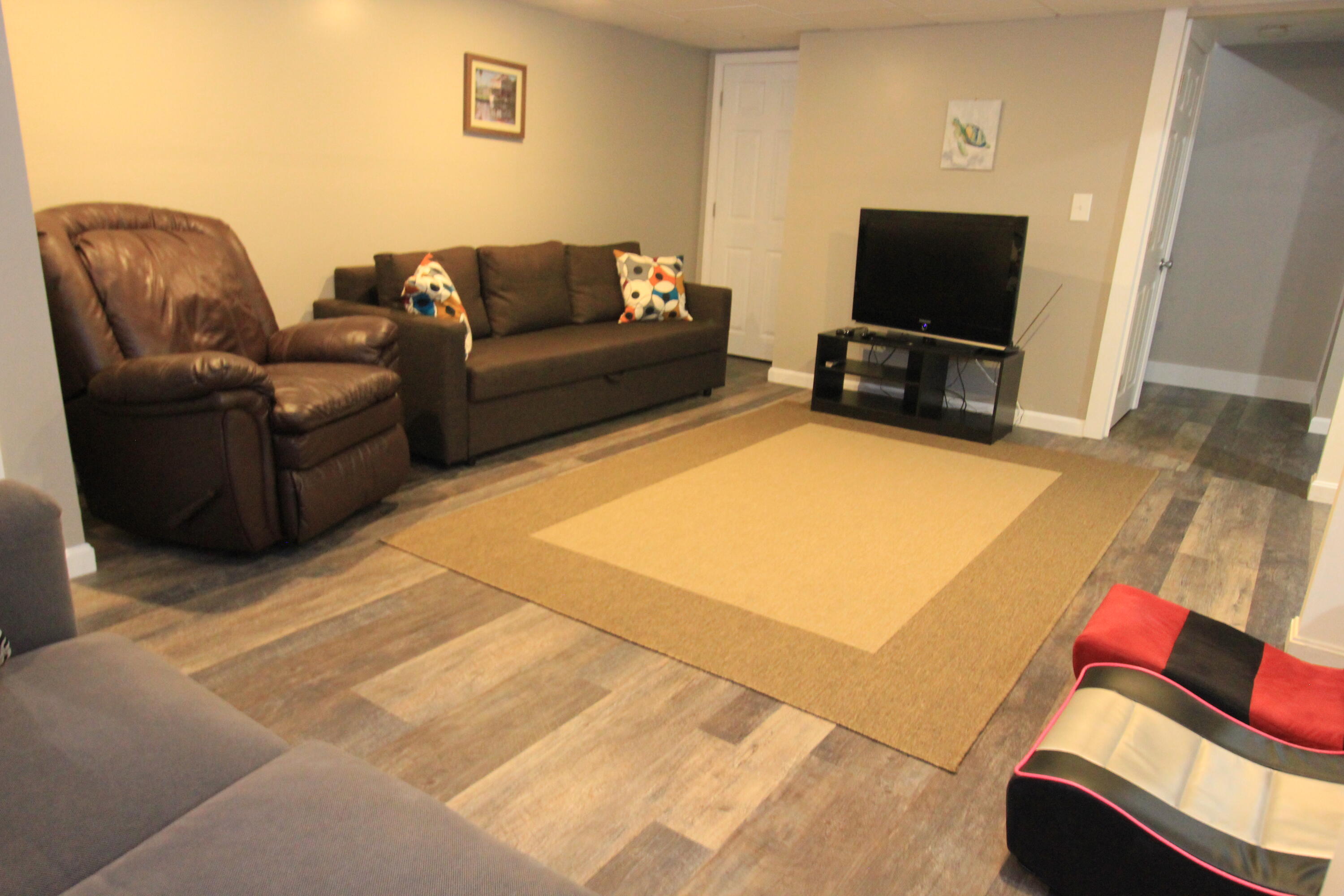 23 Nauset Road Sagamore Beach, MA 02562 - Photo 11 of 13 a living room with furniture and a flat screen tv