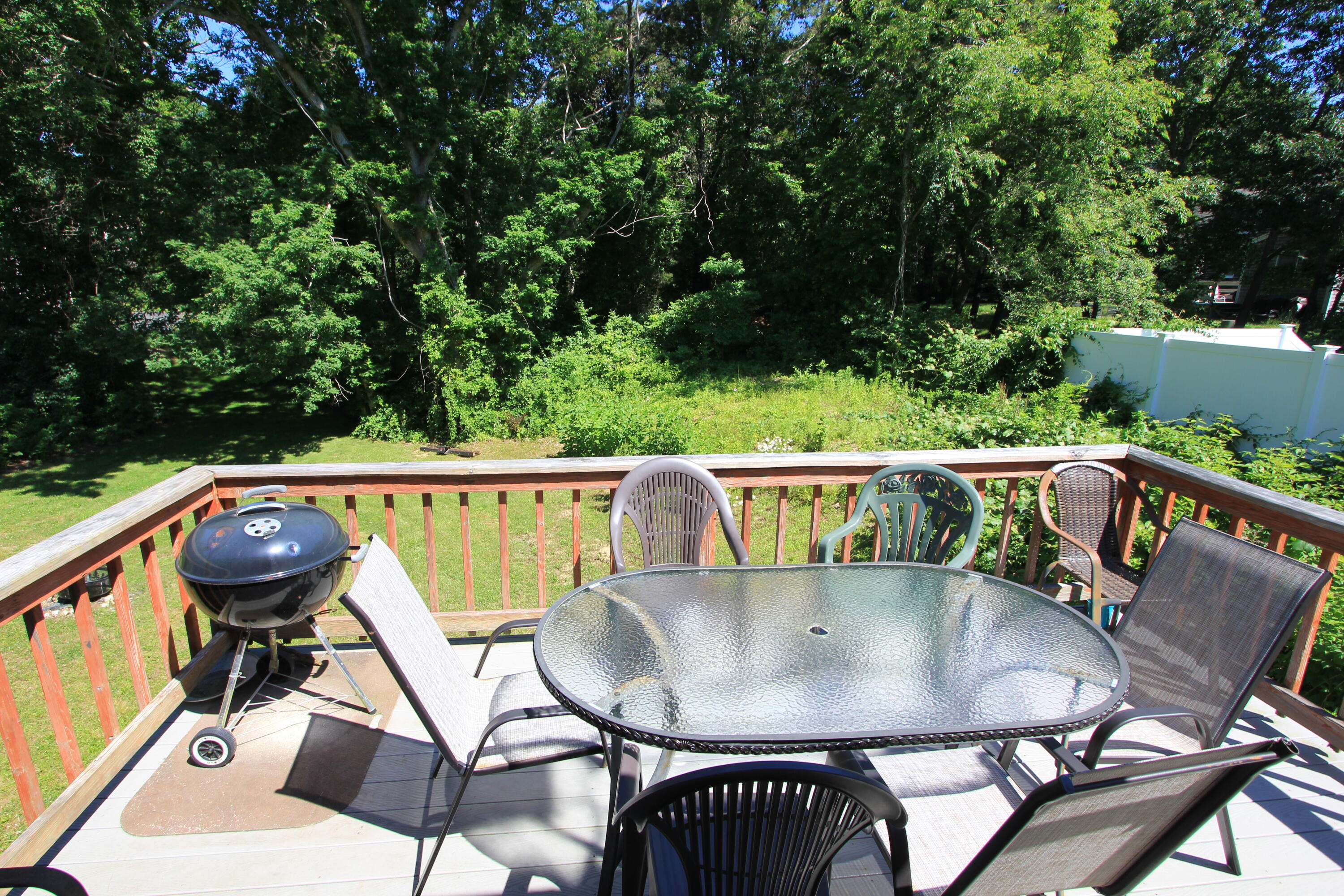 23 Nauset Road Sagamore Beach, MA 02562 - Photo 13 of 13 a balcony with a table and chairs