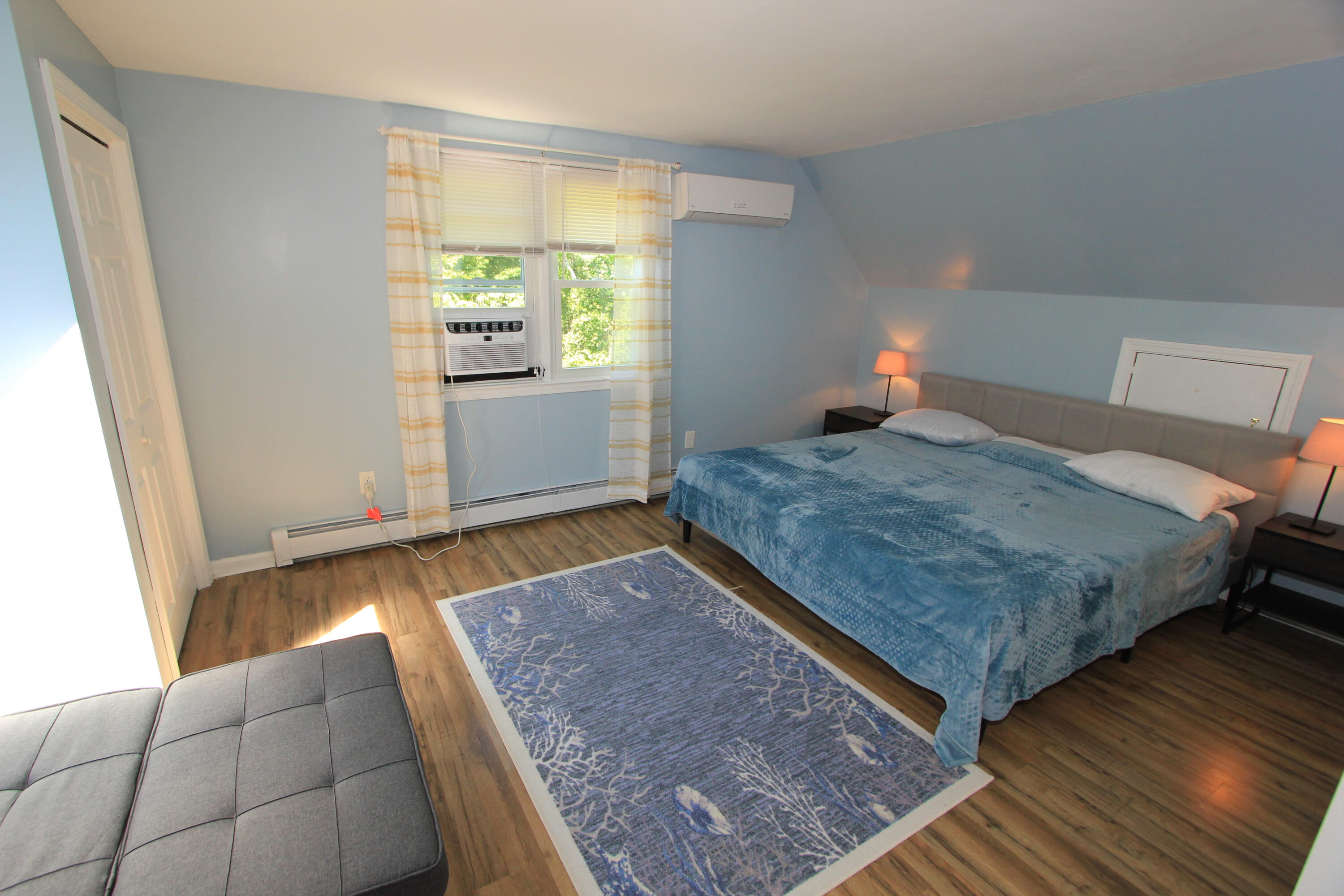 23 Nauset Road Sagamore Beach, MA 02562 - Photo 5 of 13 a bedroom with a bed and wooden floor