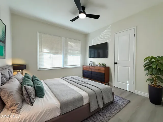 a bedroom with a bed and a flat screen tv