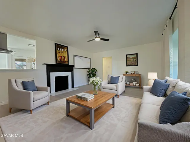 a living room with furniture a rug and a fireplace