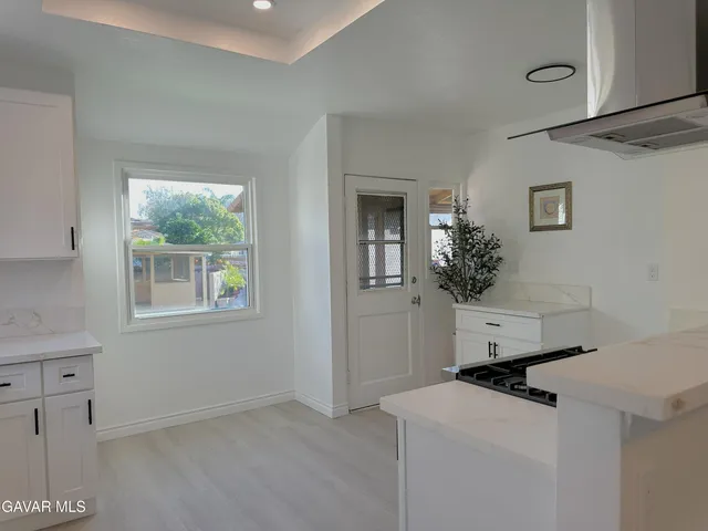 a room with a window and flowers