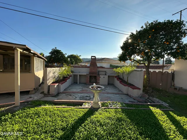 a view of a backyard house and outdoor kitchen