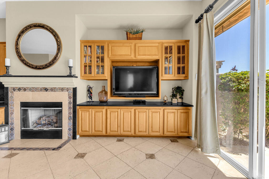 78079 Calle Norte La Quinta, CA 92253 - Photo 12 of 51 a living room with a fireplace and a flat screen tv