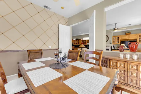a living room with furniture a rug and a table