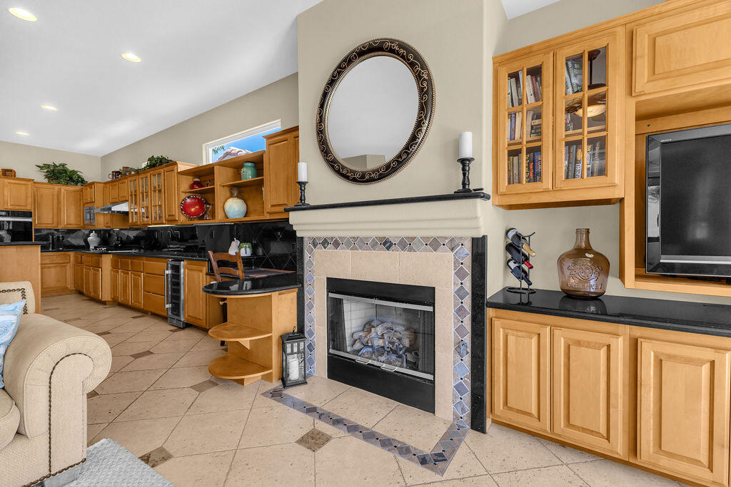 78079 Calle Norte La Quinta, CA 92253 - Photo 16 of 51 a living room with furniture a fireplace and kitchen view