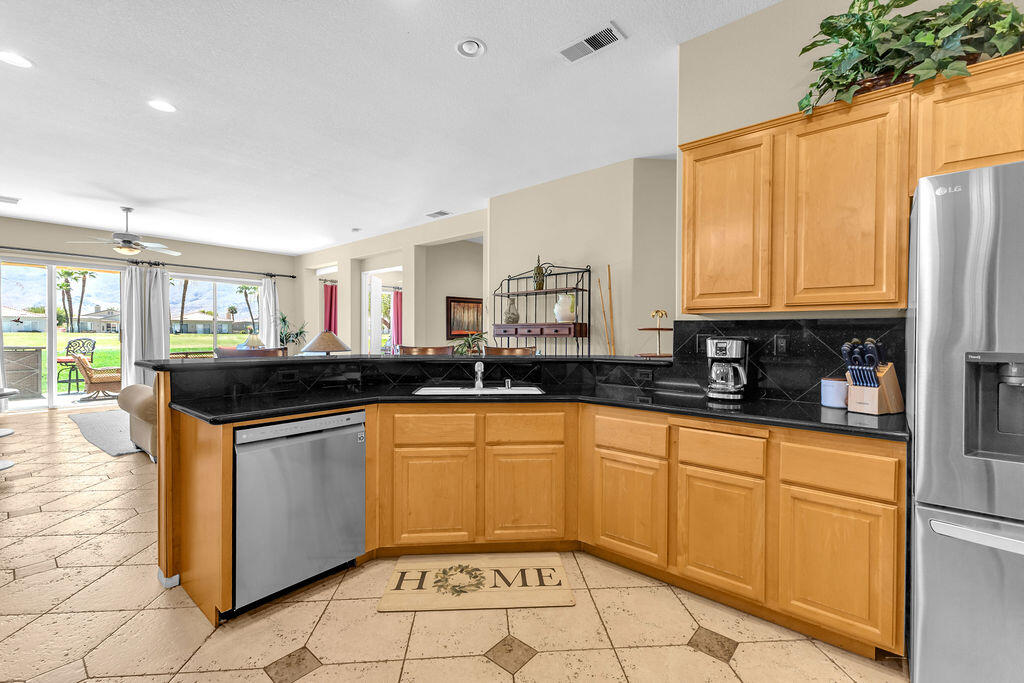 78079 Calle Norte La Quinta, CA 92253 - Photo 19 of 51 a kitchen with stainless steel appliances granite countertop a sink and cabinets