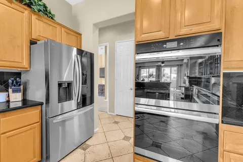 a kitchen with stainless steel appliances granite countertop a refrigerator and a stove