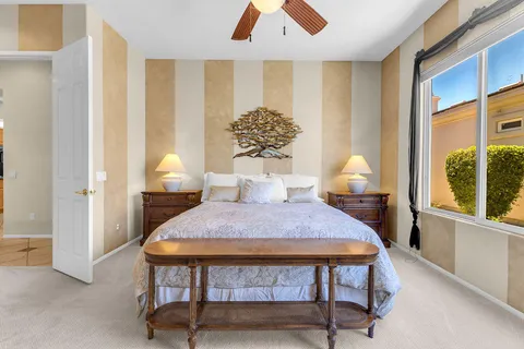 a bedroom with furniture and a window