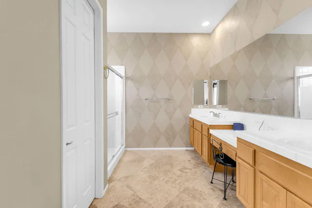 a bathroom with a sink double vanity and a mirror
