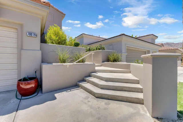 a view of a chairs and table in backyard