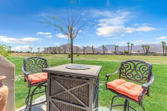 a view of a chairs and table in patio