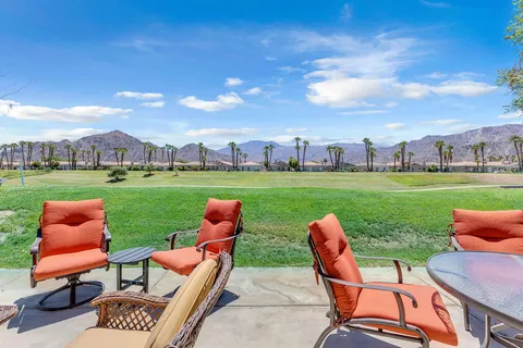 an outdoor sitting area with chairs and a table