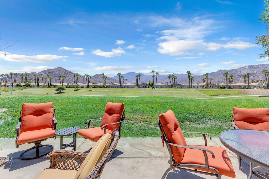 78079 Calle Norte La Quinta, CA 92253 - Photo 34 of 51 an outdoor sitting area with chairs and a table