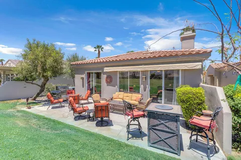 a view of a house with backyard sitting area and garden