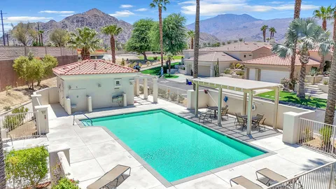 an aerial view of a house with swimming pool garden and patio