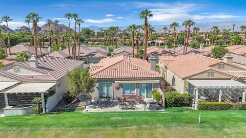 a view of a house with a garden and a yard