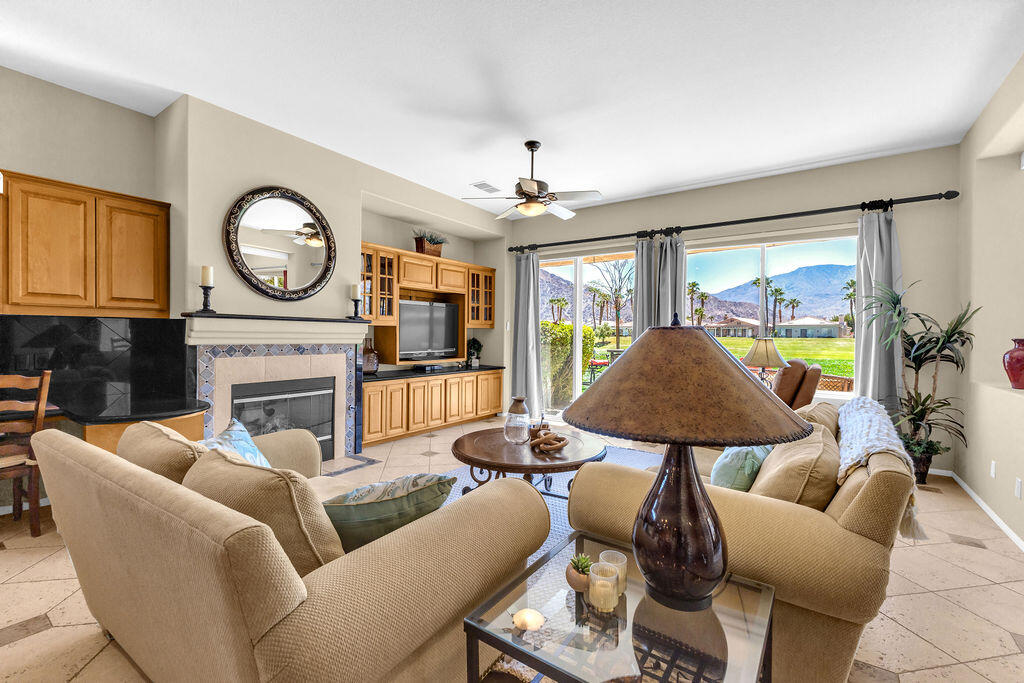 78079 Calle Norte La Quinta, CA 92253 - Photo 8 of 51 a living room with furniture a fireplace and a flat screen tv