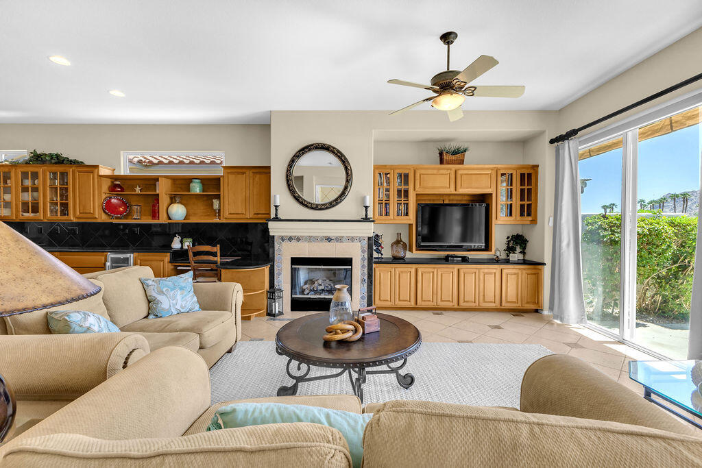 78079 Calle Norte La Quinta, CA 92253 - Photo 9 of 51 a living room with furniture a fireplace and a large window