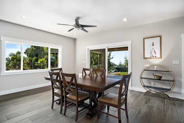 a dining room with furniture window and wooden floor
