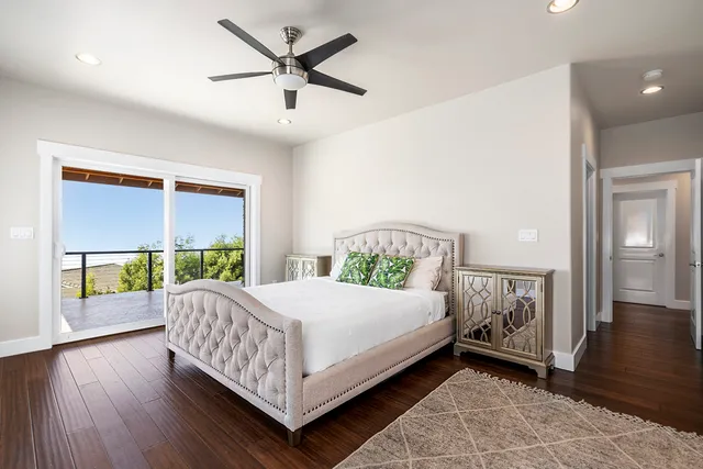 a bedroom with a bed and a large window