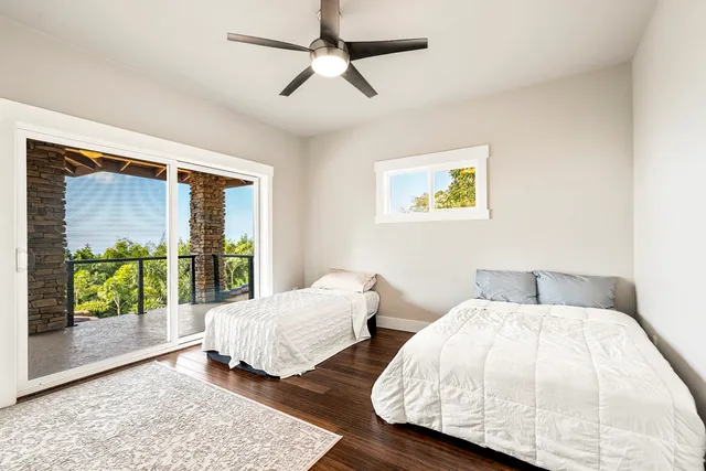 a bedroom with two beds and a large window