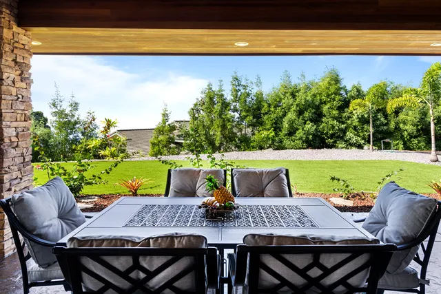 a view of a dining room with furniture and a potted plant