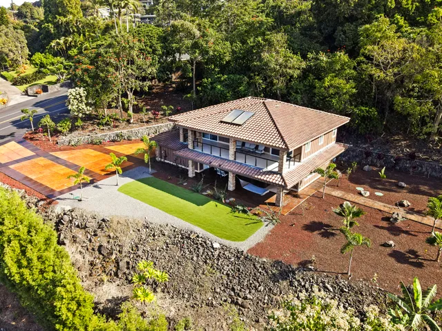 an aerial view of a house with a big yard