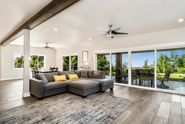 a living room with furniture and a floor to ceiling window