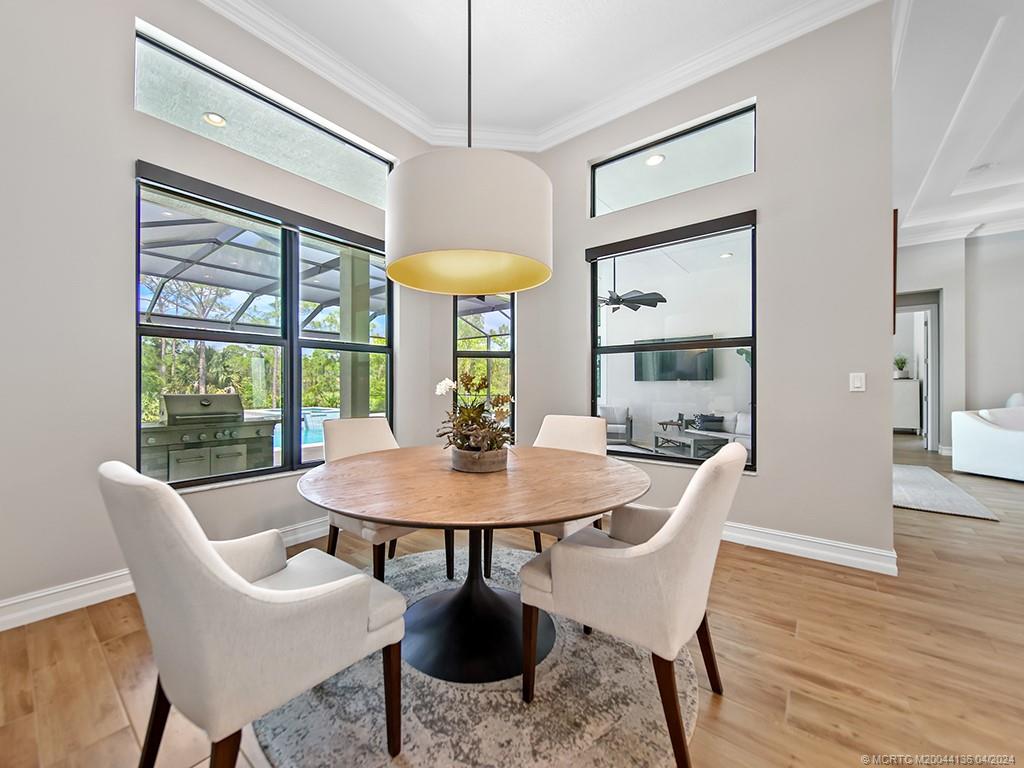 3246 Southwest Loriope Loop Palm City, FL 34990 - Photo 14 of 37 a view of a dining room with furniture window and wooden floor