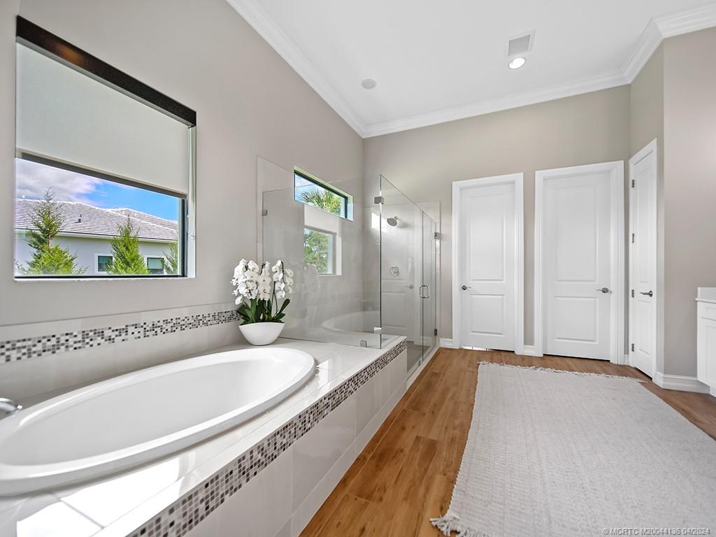 3246 Southwest Loriope Loop Palm City, FL 34990 - Photo 17 of 37 a spacious bathroom with a granite countertop tub sink and mirror