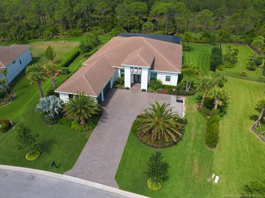 3246 Southwest Loriope Loop Palm City, FL 34990 - Photo 2 of 37 a aerial view of a house with garden