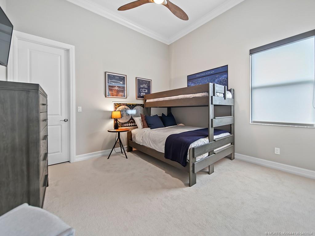 3246 Southwest Loriope Loop Palm City, FL 34990 - Photo 22 of 37 a bedroom with a bed and lamp