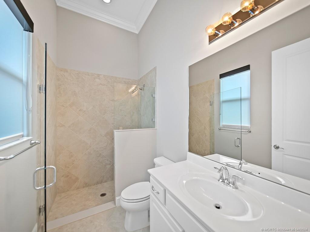 3246 Southwest Loriope Loop Palm City, FL 34990 - Photo 23 of 37 a bathroom with a sink toilet and shower
